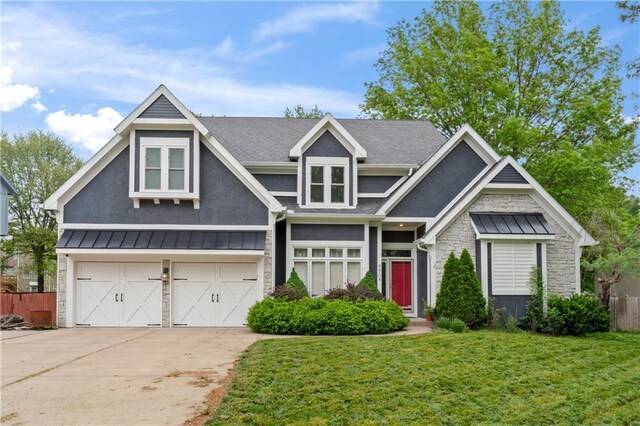 4504 NE 60th Ter, Kansas City, MO 64119 - craftsman-style house featuring a garage, a front lawn, a standing seam roof, and concrete driveway