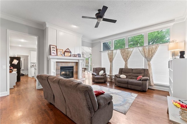 4504 NE 60th Ter, Kansas City, MO 64119 - living area featuring ornamental molding, ceiling fan, a wealth of natural light, and a tile fireplace