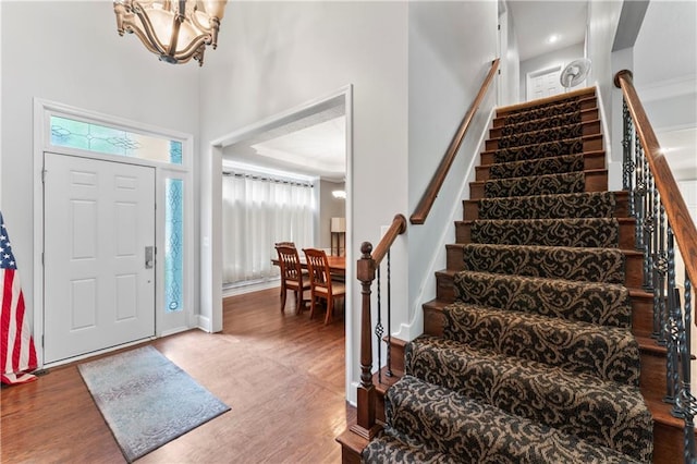 4504 NE 60th Ter, Kansas City, MO 64119 - entryway with a high ceiling, a notable chandelier, baseboards, wood finished floors, and stairway
