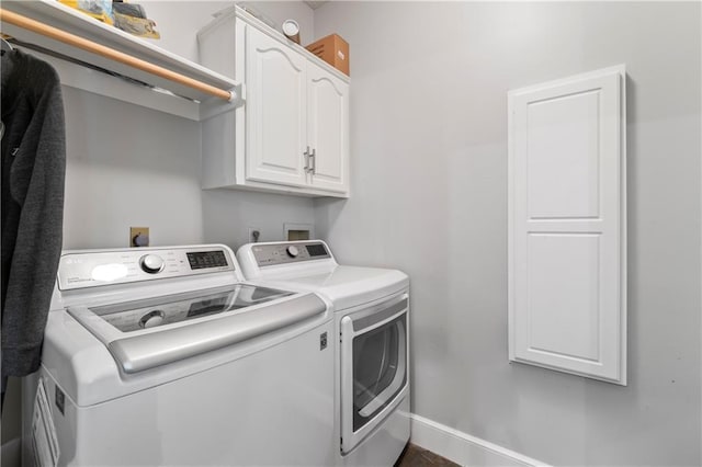 4504 NE 60th Ter, Kansas City, MO 64119 - laundry room with washing machine and clothes dryer, baseboards, and cabinet space