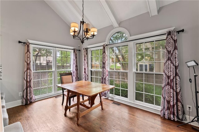 4504 NE 60th Ter, Kansas City, MO 64119 - dining area featuring beam ceiling, a notable chandelier, a wealth of natural light, and visible vents