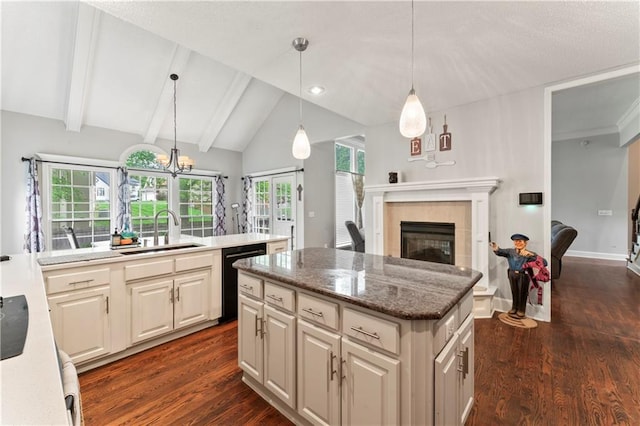 4504 NE 60th Ter, Kansas City, MO 64119 - kitchen with a tiled fireplace, a center island, dishwasher, a sink, and lofted ceiling with beams