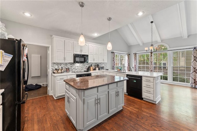 4504 NE 60th Ter, Kansas City, MO 64119 - kitchen with a peninsula, a center island, dark wood-type flooring, white cabinets, and black appliances