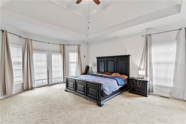 4504 NE 60th Ter, Kansas City, MO 64119 - carpeted bedroom featuring crown molding, visible vents, access to exterior, ceiling fan, and a tray ceiling