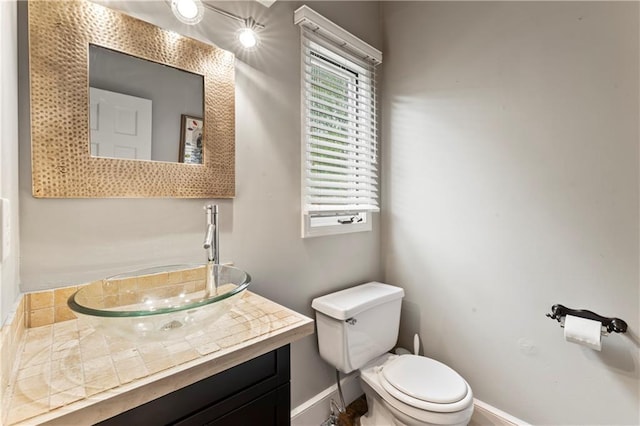 4504 NE 60th Ter, Kansas City, MO 64119 - bathroom featuring baseboards, vanity, and toilet