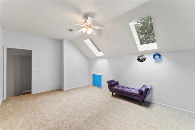 4504 NE 60th Ter, Kansas City, MO 64119 - interior space with visible vents, carpet floors, baseboards, vaulted ceiling with skylight, and a ceiling fan