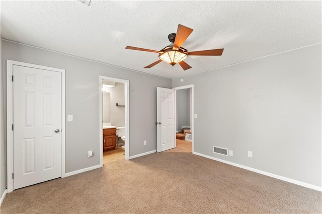 4504 NE 60th Ter, Kansas City, MO 64119 - unfurnished bedroom with visible vents, a textured ceiling, baseboards, and light carpet