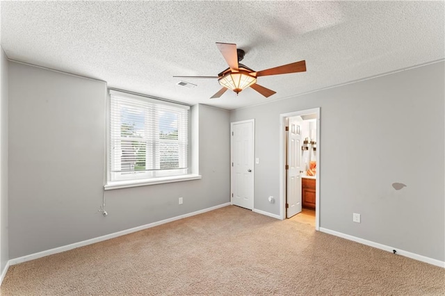 4504 NE 60th Ter, Kansas City, MO 64119 - unfurnished bedroom with a textured ceiling, light colored carpet, and baseboards