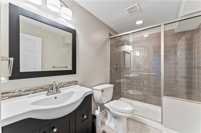 4504 NE 60th Ter, Kansas City, MO 64119 - bathroom featuring visible vents, a stall shower, vanity, tile patterned floors, and toilet