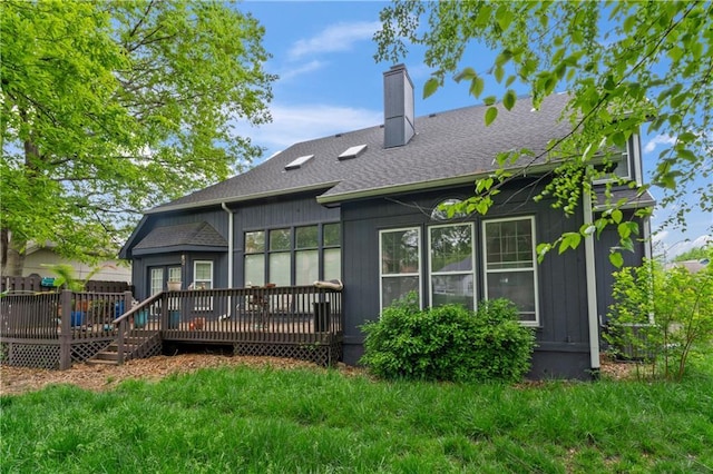 4504 NE 60th Ter, Kansas City, MO 64119 - back of house featuring roof with shingles, a chimney, a yard, and a deck