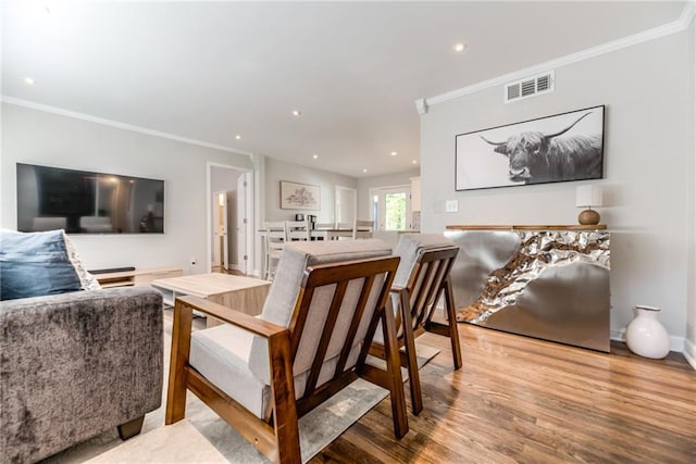 dining room with visible vents, ornamental molding, wood finished floors, and recessed lighting
