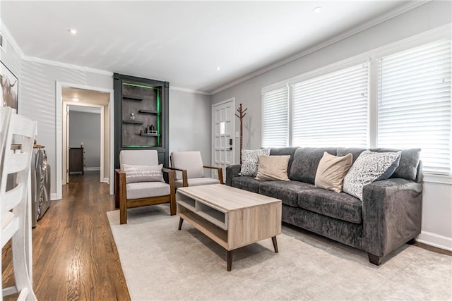 living room with crown molding, plenty of natural light, and wood finished floors