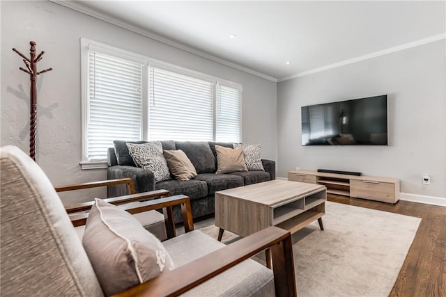 living room featuring crown molding, baseboards, and wood finished floors