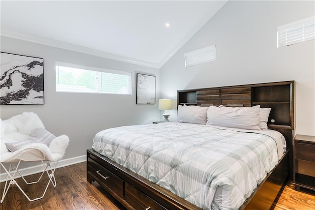 bedroom featuring baseboards, ornamental molding, lofted ceiling, and wood finished floors