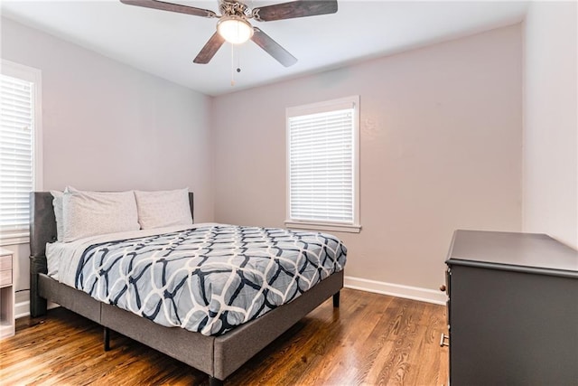 bedroom with baseboards, ceiling fan, and wood finished floors