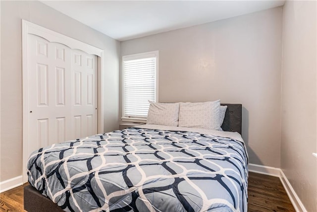 bedroom with baseboards, a closet, and wood finished floors
