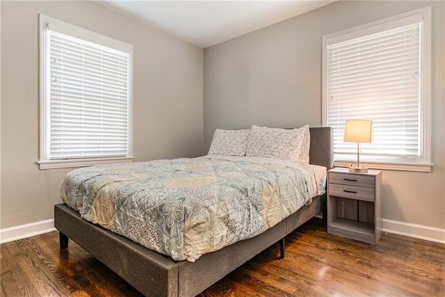 bedroom featuring baseboards and wood finished floors