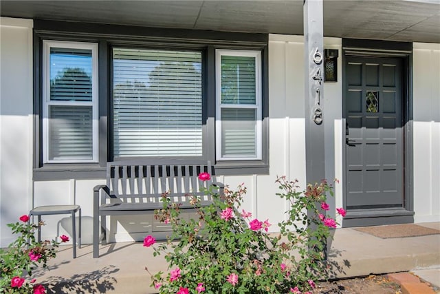 view of exterior entry featuring covered porch