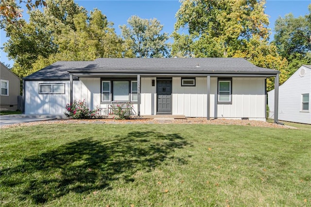 ranch-style house with a porch, board and batten siding, and a front yard