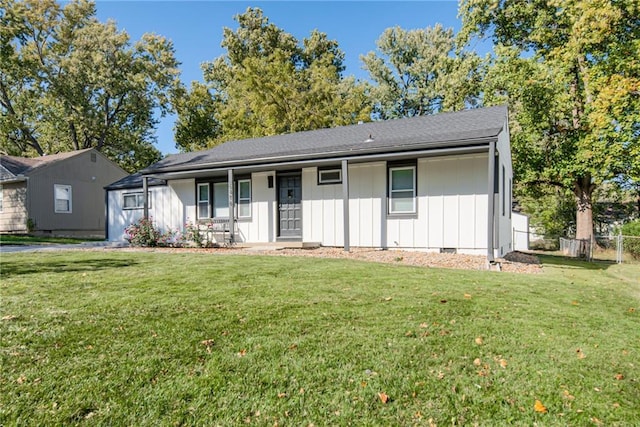 ranch-style house with board and batten siding, crawl space, fence, and a front lawn