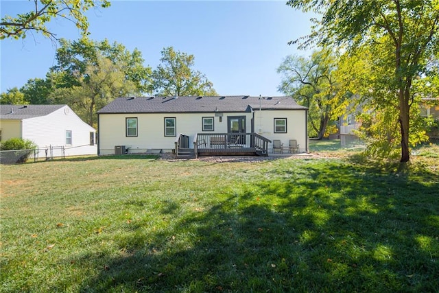 back of property featuring central AC, a yard, a deck, and fence