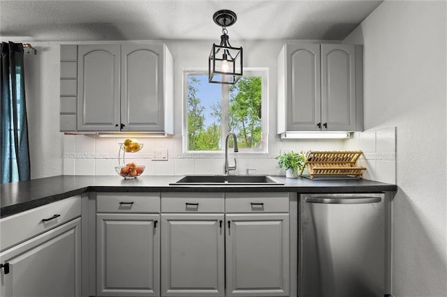 bar featuring a sink, a textured ceiling, decorative backsplash, stainless steel dishwasher, and pendant lighting