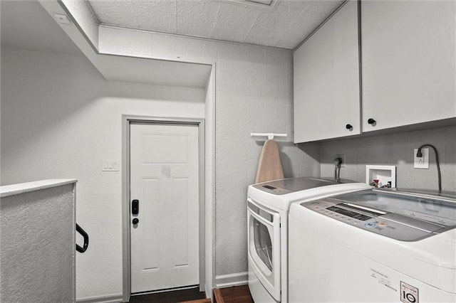 laundry room with cabinet space, dark wood-style floors, and washer and dryer