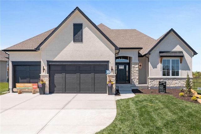 view of front of home featuring stone siding, concrete driveway, a garage, stucco siding, and a front lawn