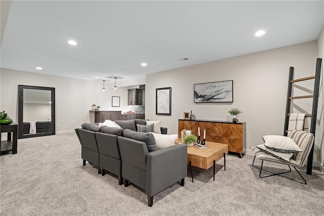 living area with light colored carpet, visible vents, and recessed lighting