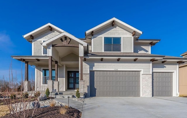 view of front of property with concrete driveway, a garage, and stucco siding