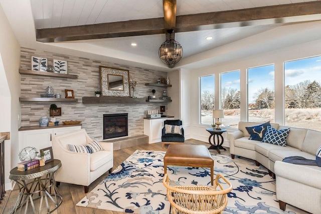 living area featuring beamed ceiling, a tiled fireplace, recessed lighting, and wood finished floors