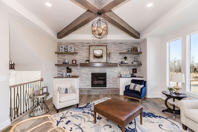 living area featuring wood finished floors, a fireplace, beamed ceiling, and recessed lighting