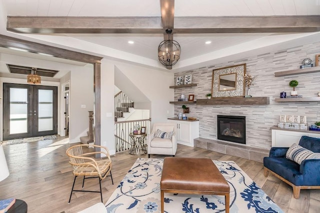 living area featuring french doors, beam ceiling, recessed lighting, stairway, and light wood-style floors