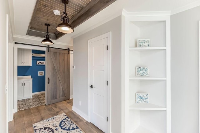 interior space with baseboards, a barn door, wood ceiling, and hardwood / wood-style flooring