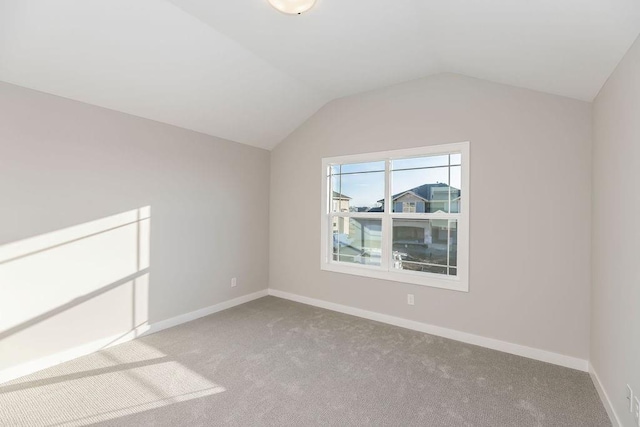 additional living space featuring carpet flooring, baseboards, and lofted ceiling