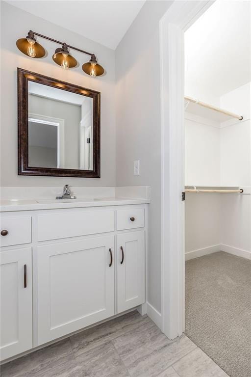 bathroom with baseboards and vanity