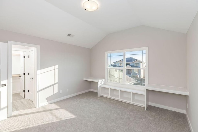 additional living space featuring lofted ceiling, carpet flooring, baseboards, and visible vents