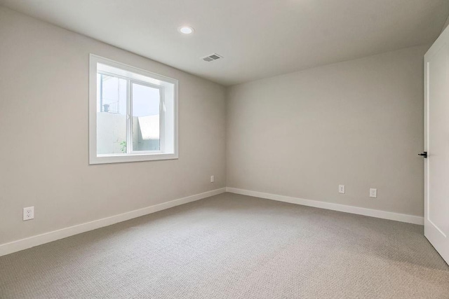 carpeted spare room with recessed lighting, baseboards, and visible vents