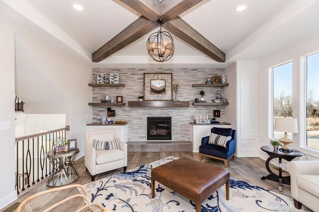 25054 W 141st St, Olathe, KS 66061 - living area with a tiled fireplace, recessed lighting, wood finished floors, and beamed ceiling