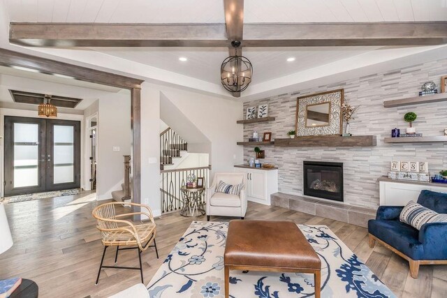 25054 W 141st St, Olathe, KS 66061 - living room featuring light wood-style flooring, french doors, recessed lighting, beamed ceiling, and stairway