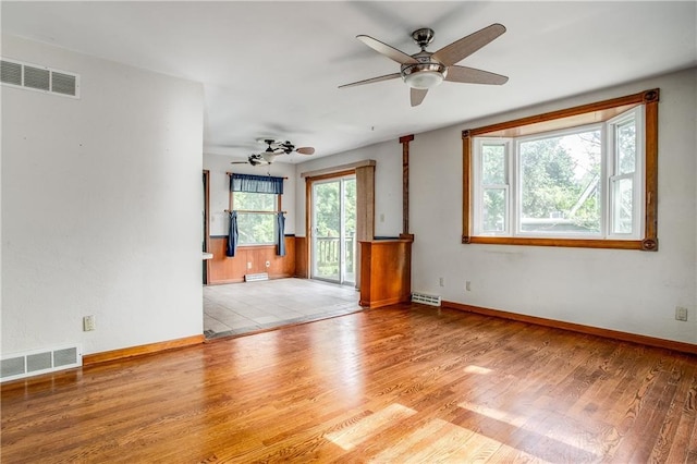 2806 S Whitney Ave, Independence, MO 64057 - unfurnished room featuring ceiling fan, wood finished floors, and baseboards