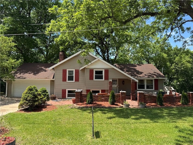 2806 S Whitney Ave, Independence, MO 64057 - split level home featuring a garage, a chimney, a front yard, and concrete driveway