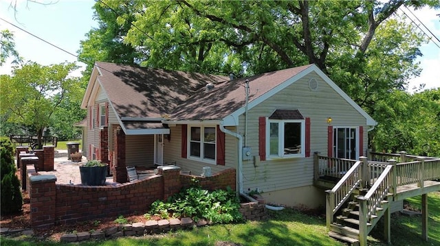 2806 S Whitney Ave, Independence, MO 64057 - view of front of home featuring a wooden deck, roof with shingles, stairway, and a patio