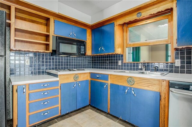 2806 S Whitney Ave, Independence, MO 64057 - kitchen with black appliances, tasteful backsplash, light countertops, and a sink