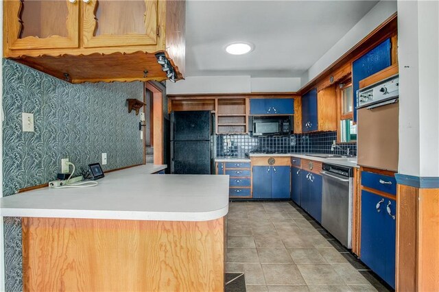 2806 S Whitney Ave, Independence, MO 64057 - kitchen featuring black appliances, open shelves, backsplash, a peninsula, and light tile patterned flooring