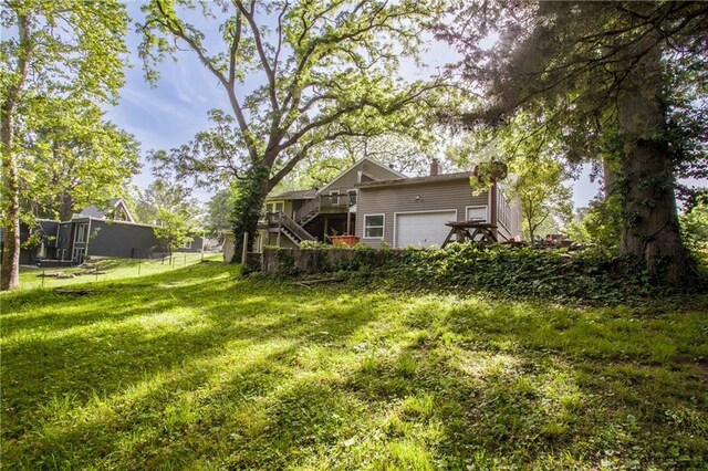 2806 S Whitney Ave, Independence, MO 64057 - view of grassy yard featuring stairs and an attached garage