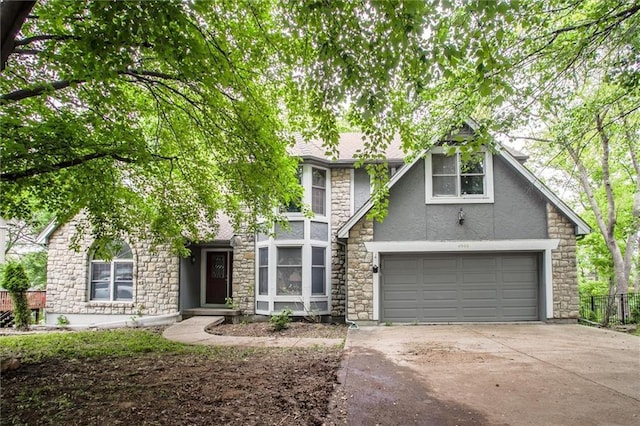 4008 NW 75th St, Kansas City, MO 64151 - tudor home featuring stone siding, stucco siding, driveway, and a garage