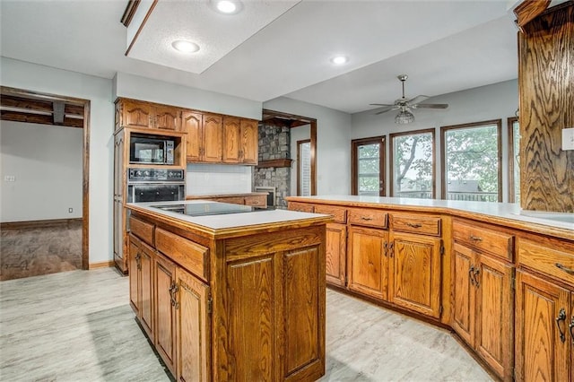 4008 NW 75th St, Kansas City, MO 64151 - kitchen with brown cabinets, black appliances, backsplash, a kitchen island, and ceiling fan