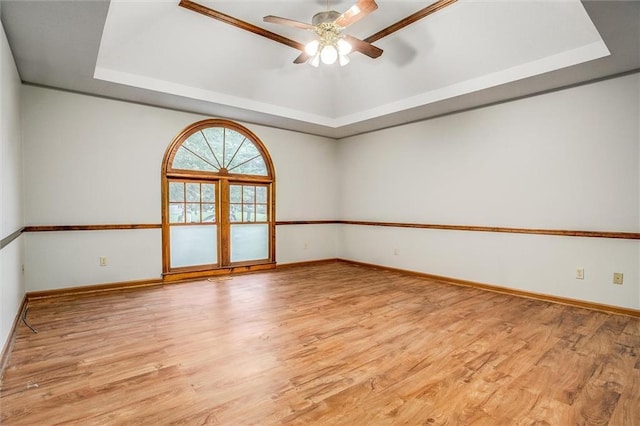 4008 NW 75th St, Kansas City, MO 64151 - spare room with a tray ceiling, ceiling fan, light wood finished floors, and baseboards