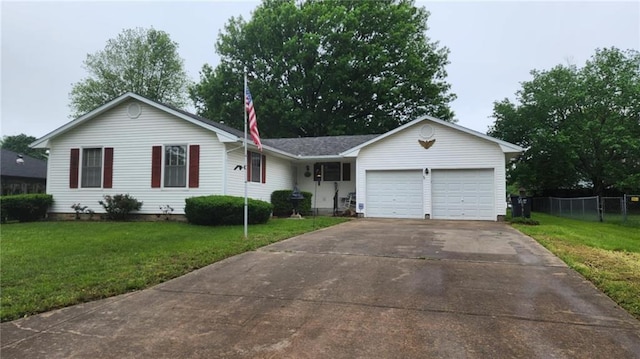 single story home with a garage, fence, a front yard, and concrete driveway